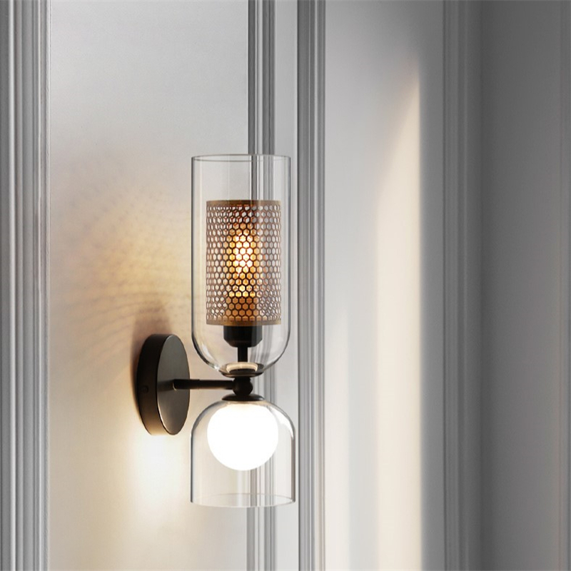 NordLight LED wall lamp mounted on white dining room wall with brass honeycomb detail.
