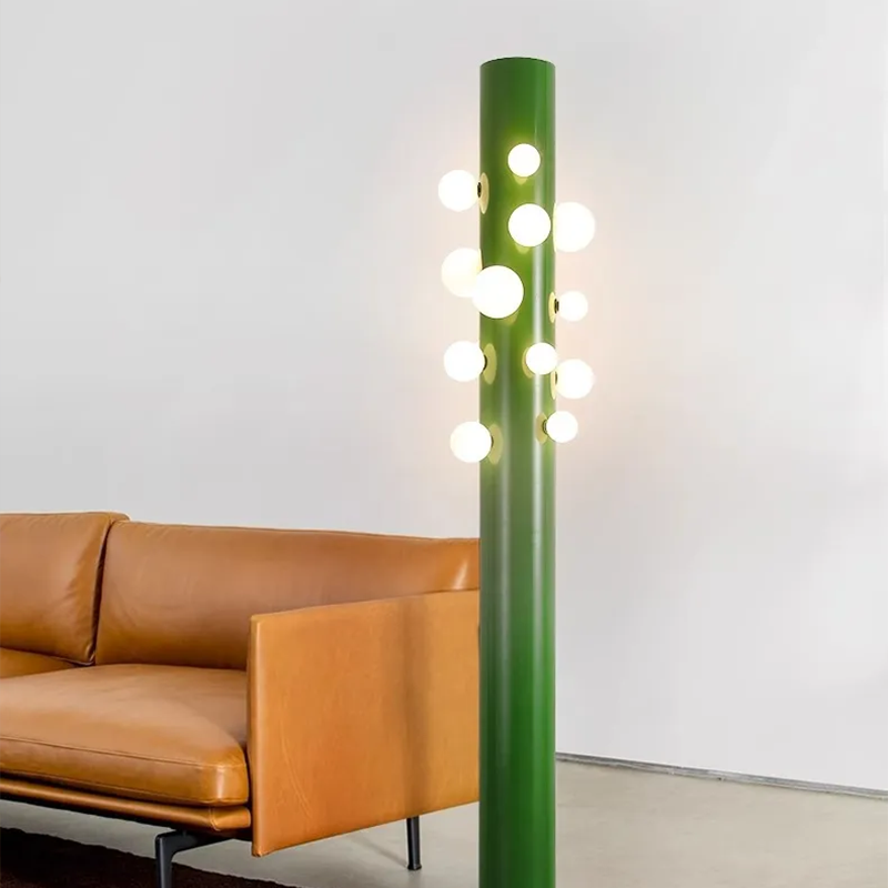 Close-up of the base and fluted vertical structure of the green cylinder glass floor lamp.