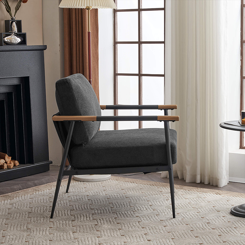 The black chenille lounge chair positioned in an office environment, showcasing its modern design.