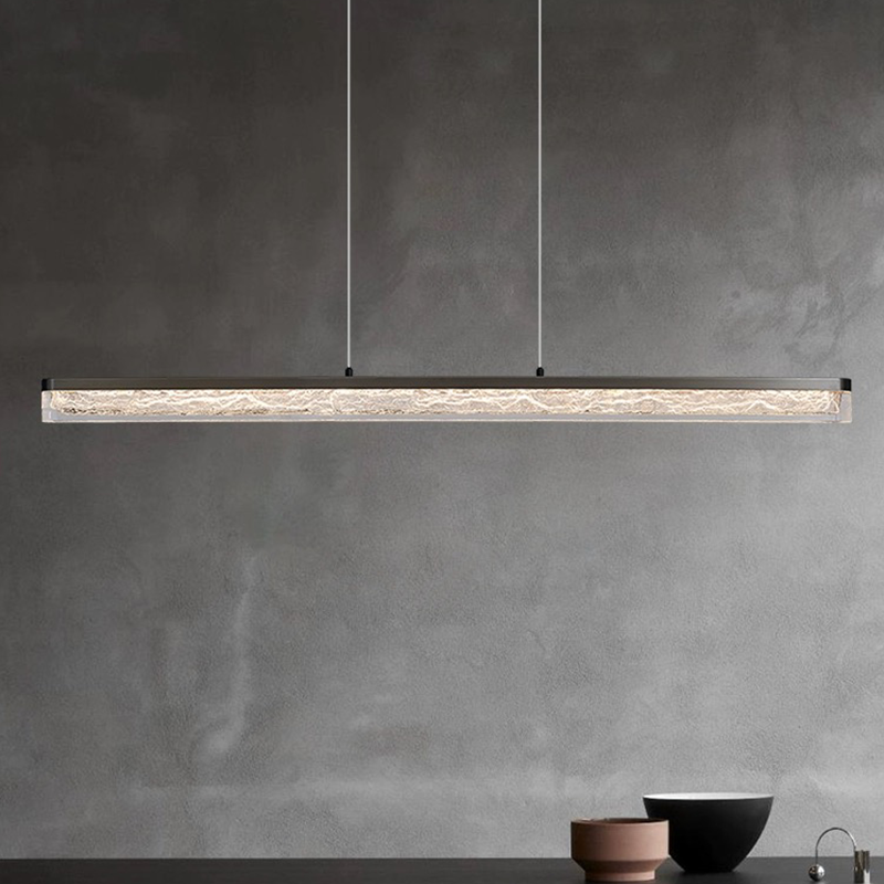 Sleek modern LED pendant light showcased above a contemporary dining table.