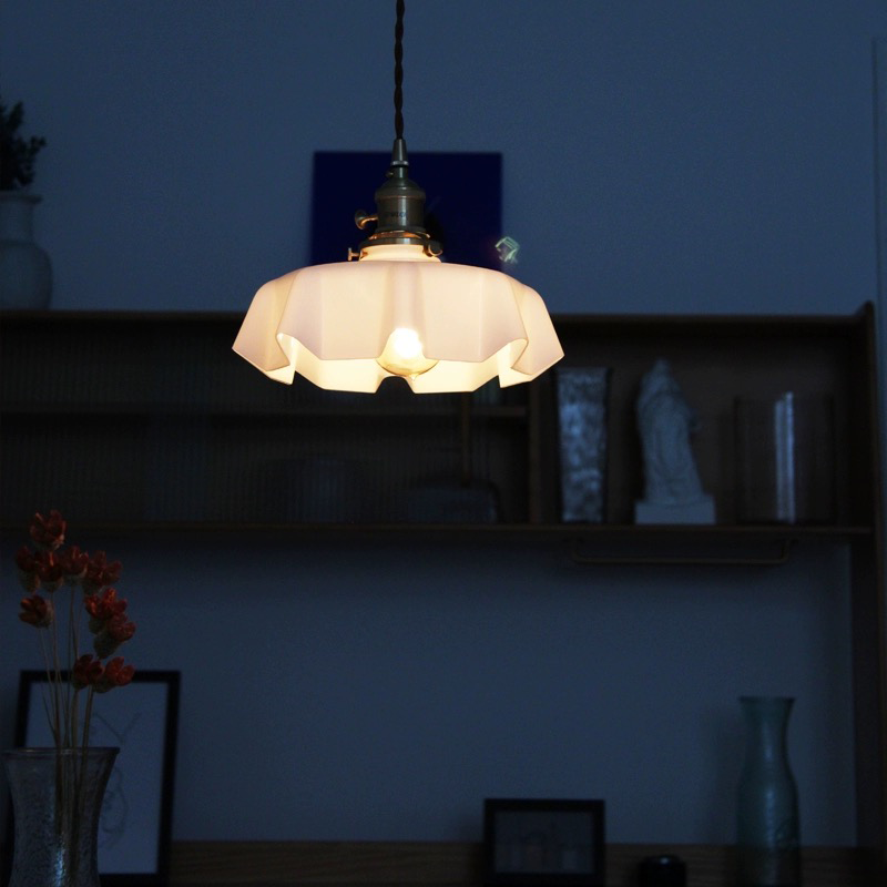 Vintage Elegance Wavy Glass Pendant Light illuminating a cozy living room, creating a warm ambiance.