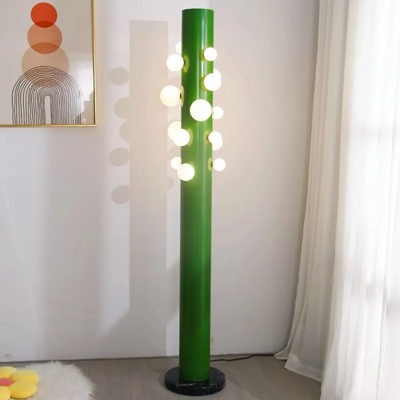 Modern lighting ambiance created by the green glass floor lamp in a spacious foyer.