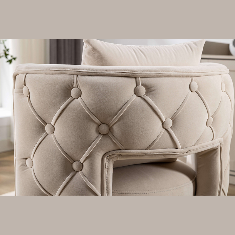 Beige swivel barrel chair with gold legs placed in a modern office.