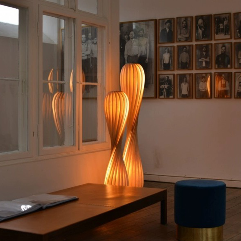 The fabric LED floor lamp illuminating a cozy reading nook.