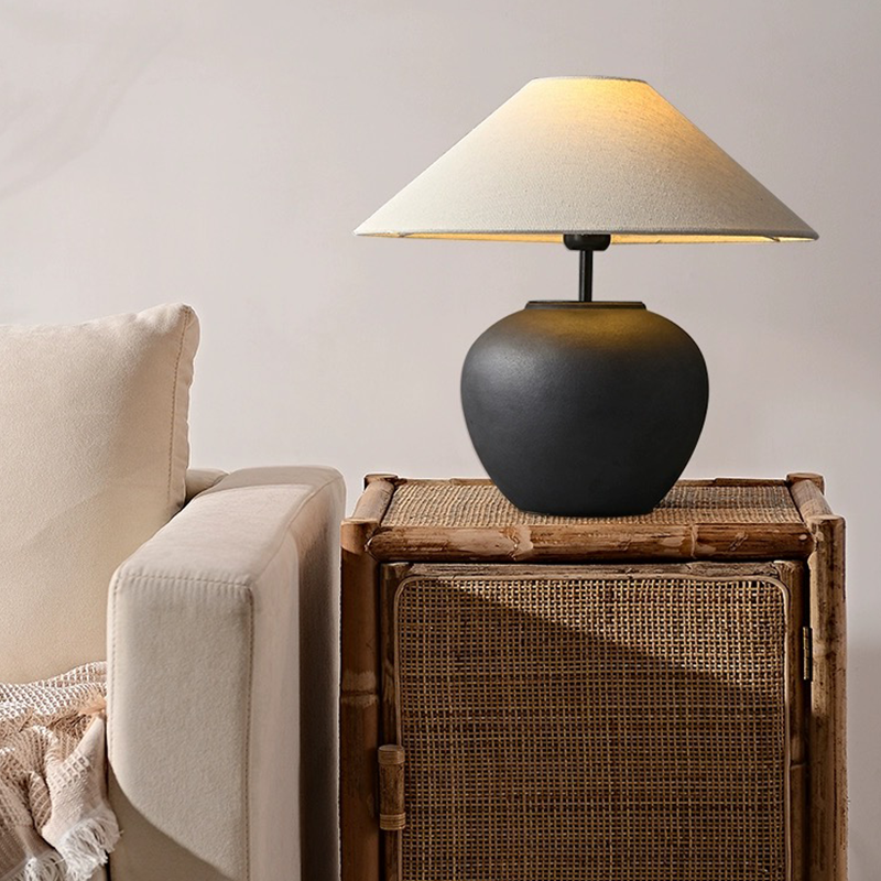 Side angle of the Japanese pottery lamp highlighting the rustic ceramic texture and adjustable switch.