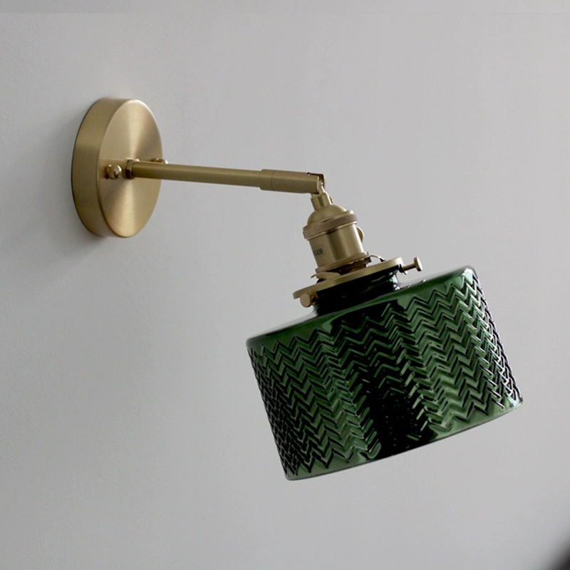 The green glass lamp highlighted in a stylish hallway, demonstrating its decorative appeal.