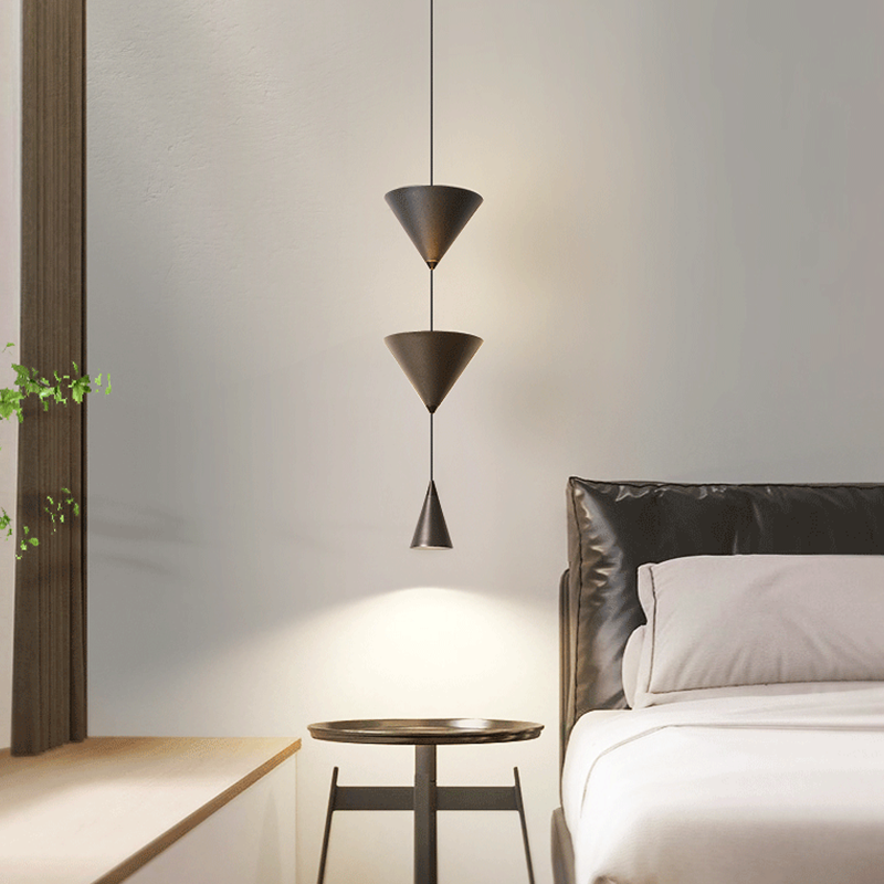 Front view of modern cone-shaped LED pendant light in a dining room setting.