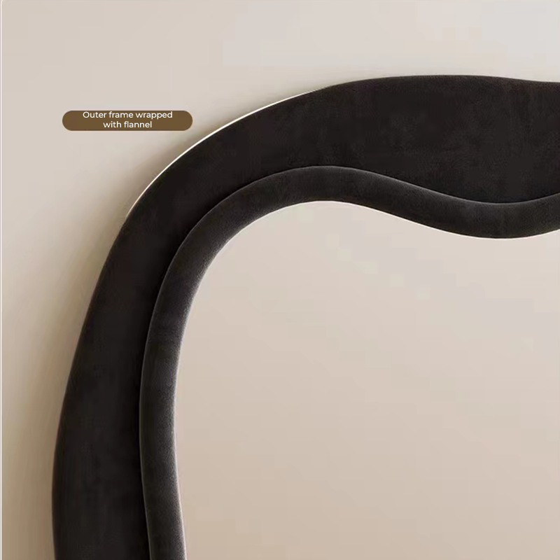 Elegant wavy black full-length mirror showcasing its unique wave design in a bright living room.