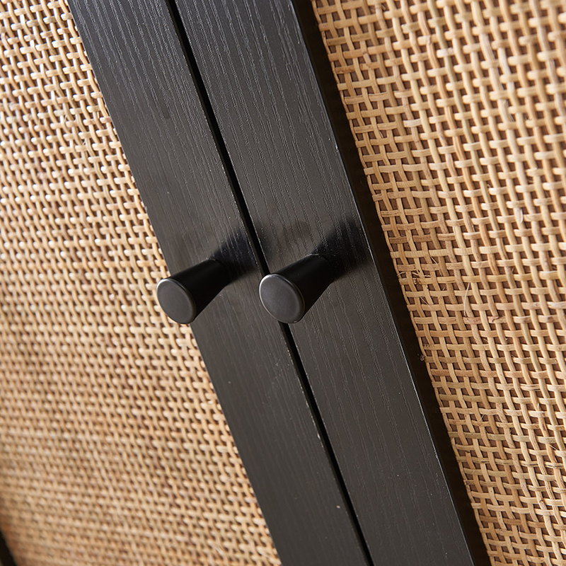 Angle shot highlighting the texture of the cheap sideboard cabinet with rattan doors against wood flooring