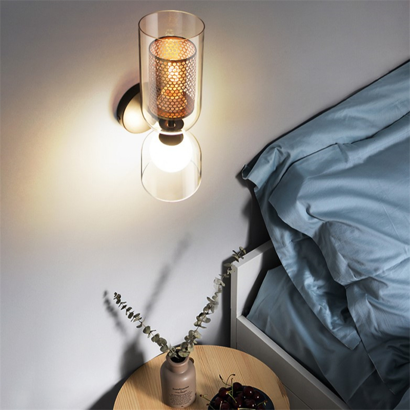 NordLight LED wall lamp mounted on white dining room wall with brass honeycomb detail.