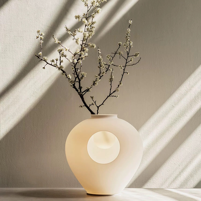 LumaBloom table lamp placed in a hotel room with minimalist decor