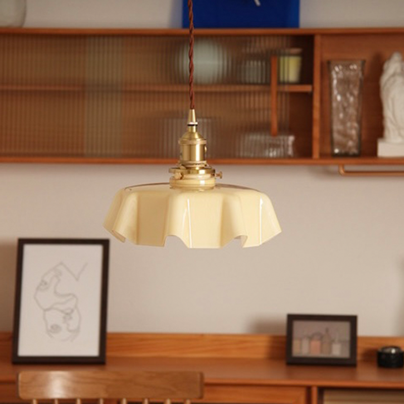 Wavy glass pendant light hanging in a stylish kitchen, showcasing its elegant design.