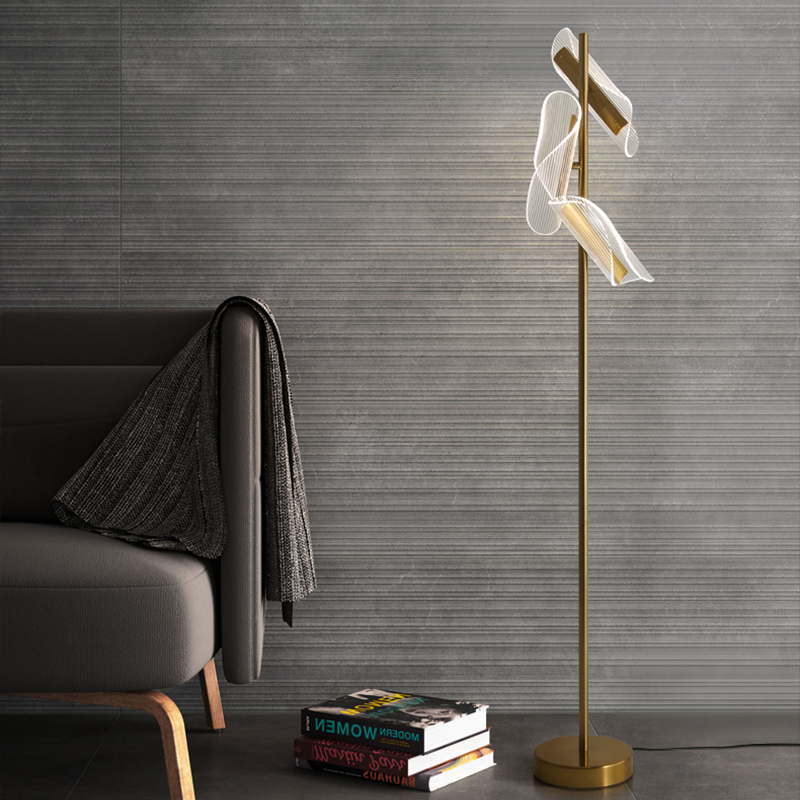 Modern brass stand LED floor lamp in a cozy reading nook, providing ambient light.