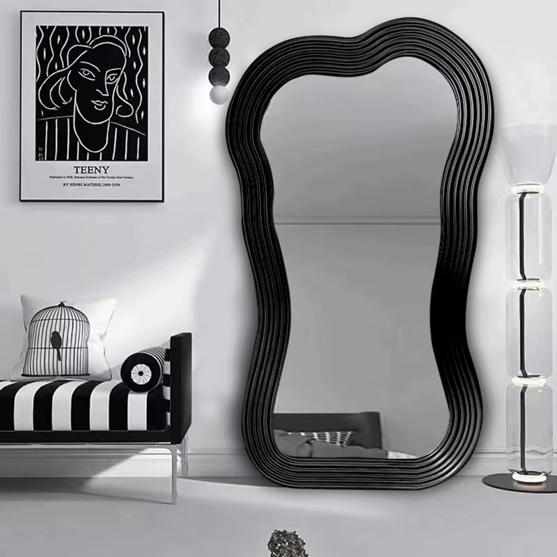 Irregular floor mirror positioned elegantly in a minimalist hallway for functional decor.