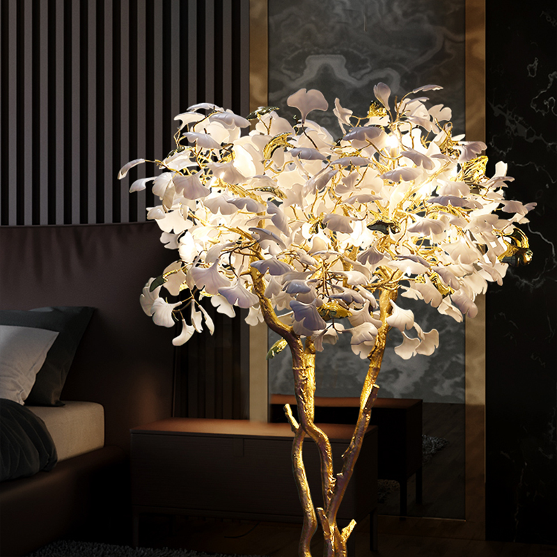 Ginkgo tree floor lamp next to a comfortable reading chair, creating an inviting atmosphere.