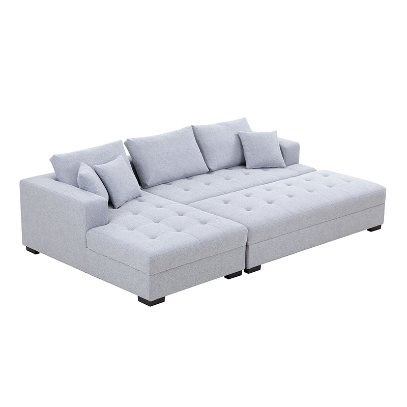 Light grey tufted sectional sofa in a contemporary living room setting
