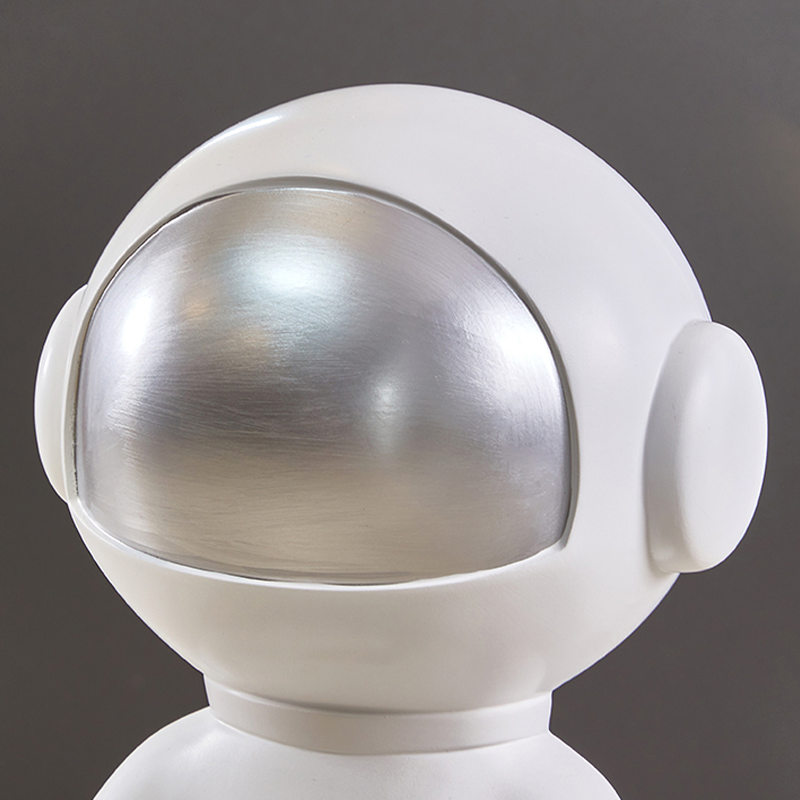 Close-up of the astronaut lamp showcasing its unique design and frosted glass shade.