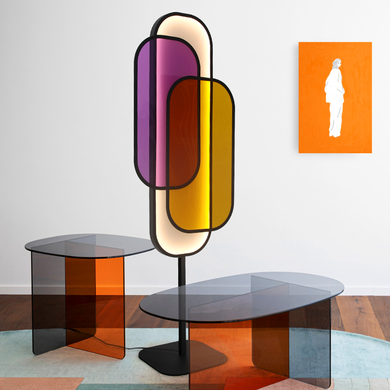 ChromaGlow floor lamp illuminating a cozy bedroom with multicolor LED lights.