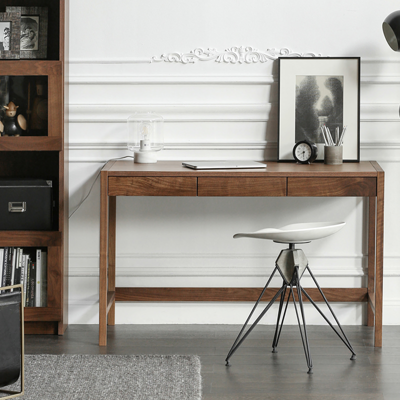Front view of the modern walnut writing desk showing its sleek design and hidden storage.