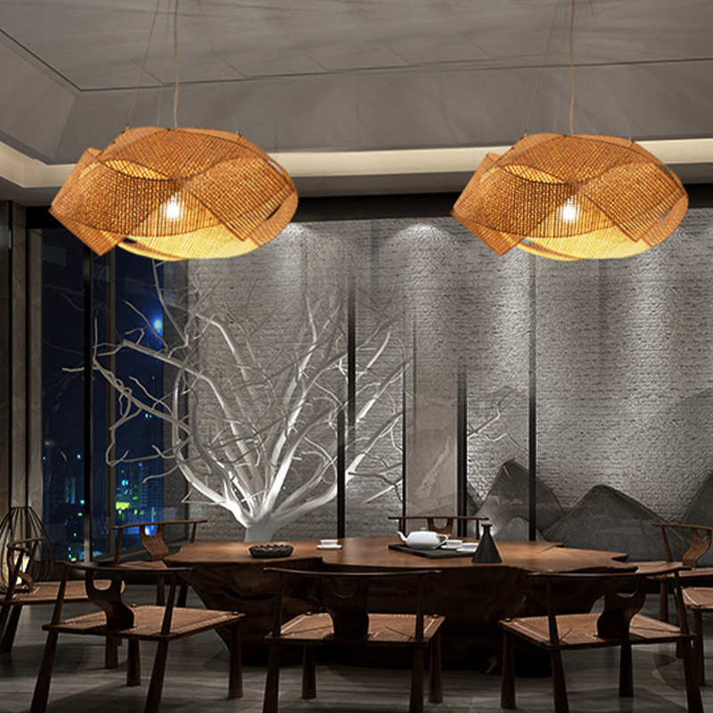 Close-up view of the vintage bamboo light hanging above a dining table, highlighting its natural texture.