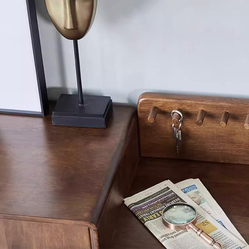 Side angle of rubber wood shoe cabinet with double doors placed in a modern entryway with boots and accessories