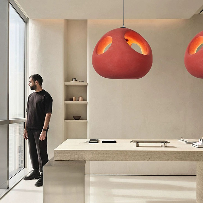 Nordic handwoven pendant light showcasing its intricate design and warm red hue.
