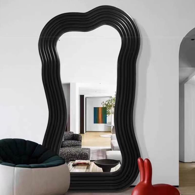 Irregular floor mirror positioned elegantly in a minimalist hallway for functional decor.