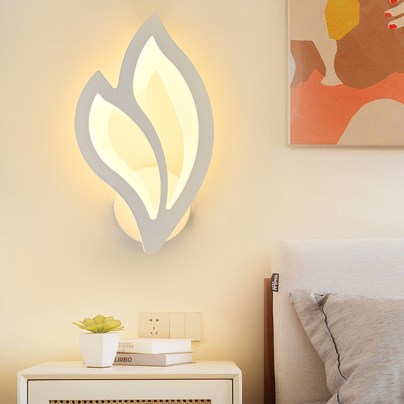 Elegant white leaf LED wall sconce showcased in a cozy cafe setting.