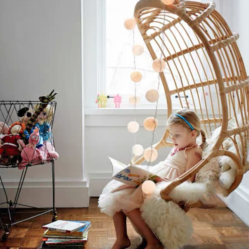 Side view of the rocking chair, highlighting its elegant curves and durable cane frame.