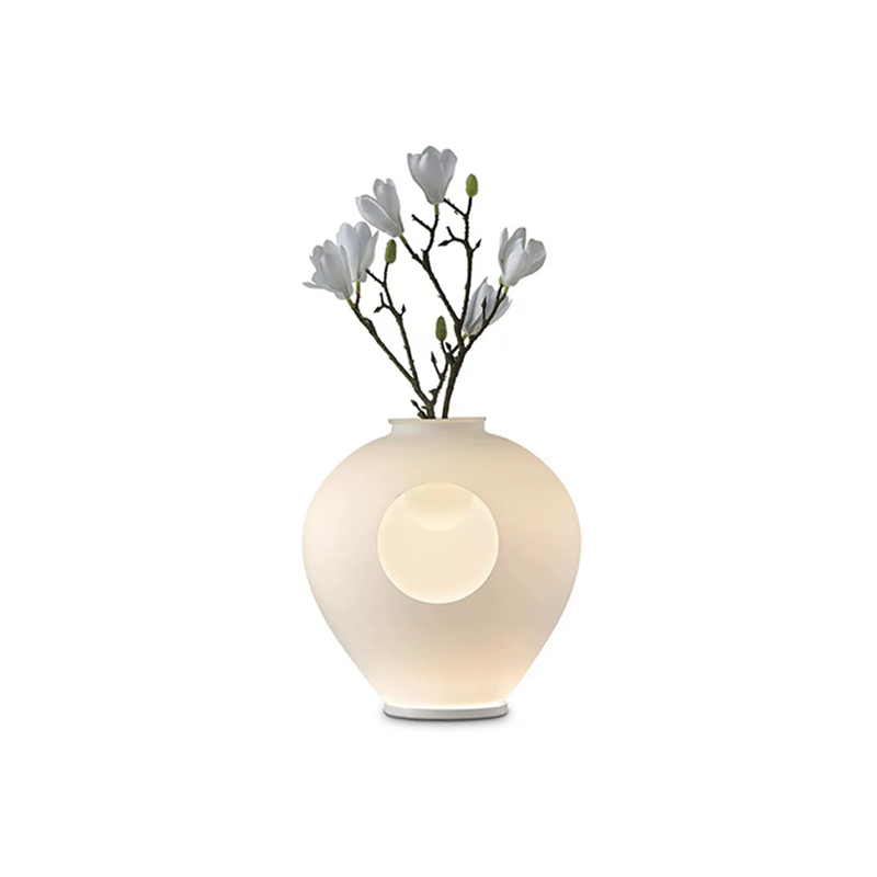 LumaBloom table lamp placed in a hotel room with minimalist decor