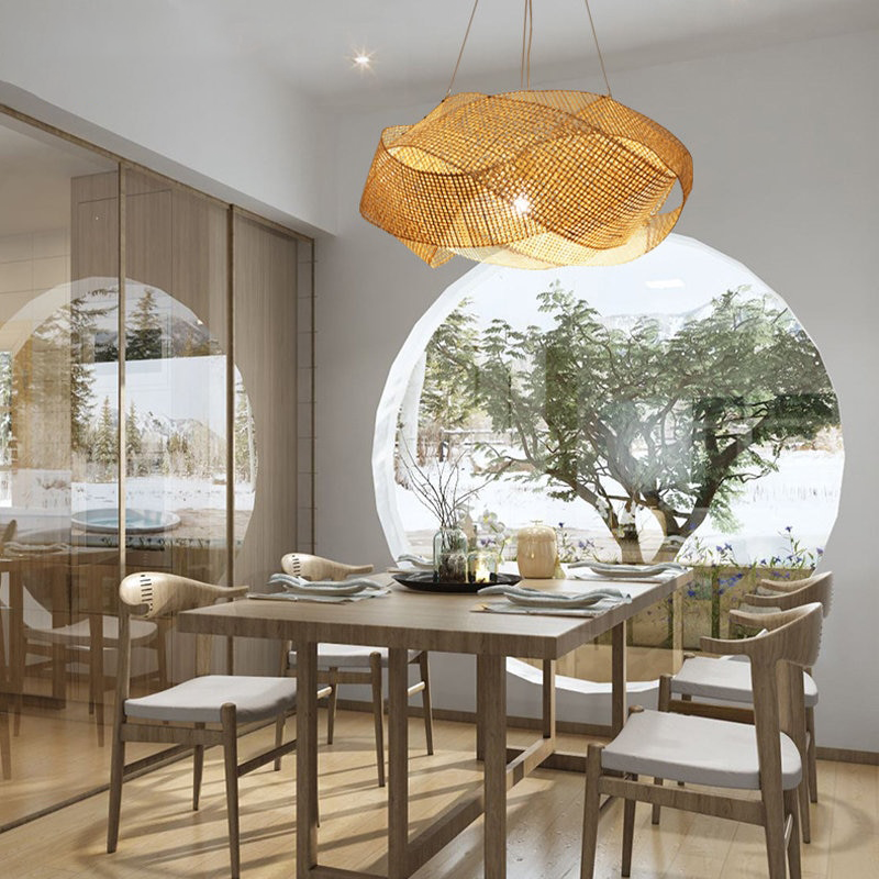 Bamboo rattan pendant light showcasing its intricate design and warm glow in a cozy living room.