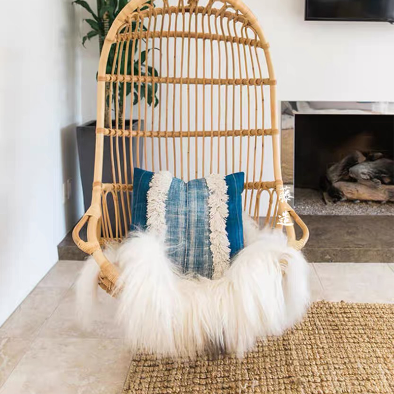 Elegant Rattan Indoor Glider Swing Chair in natural wood finish, perfect for cozy balconies.