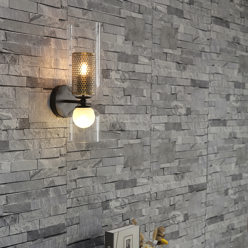 Side view of modern lighting wall sconce casting warm glow on hallway wall decor.