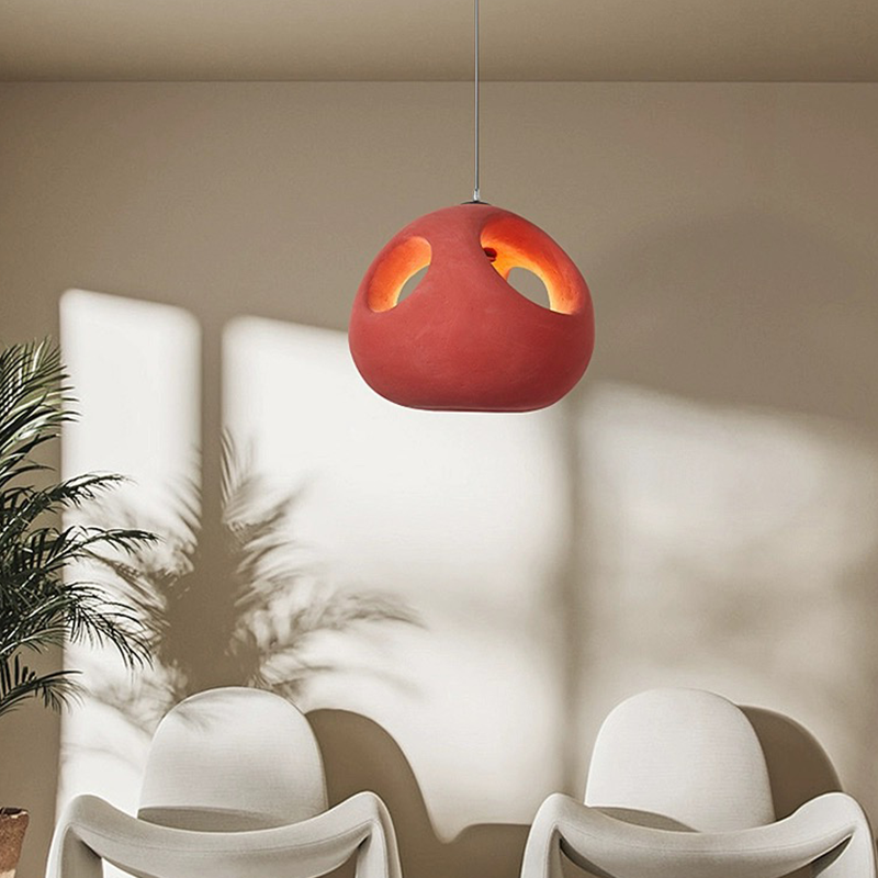 Nordic handwoven pendant light showcasing its intricate design and warm red hue.