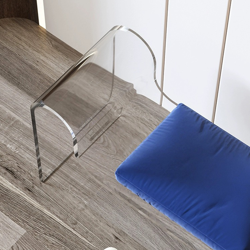 A chic white acrylic entryway bench in a modern hallway setting.