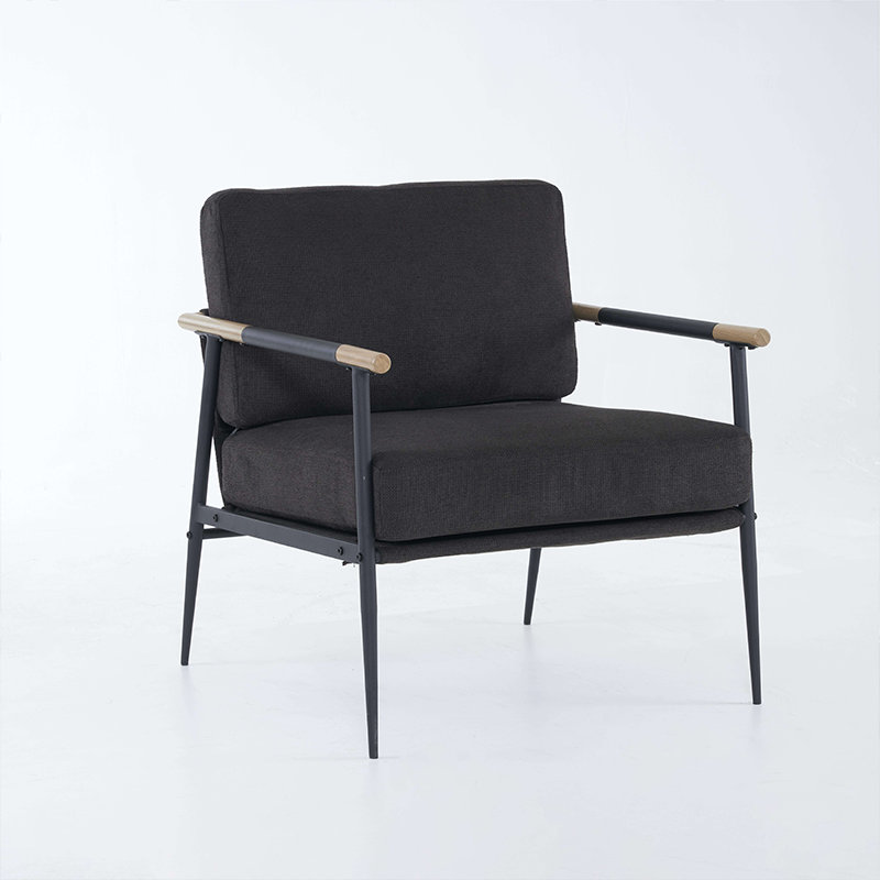 Side view of the sleek black chenille lounge chair with a metal frame in a cozy living room setting.