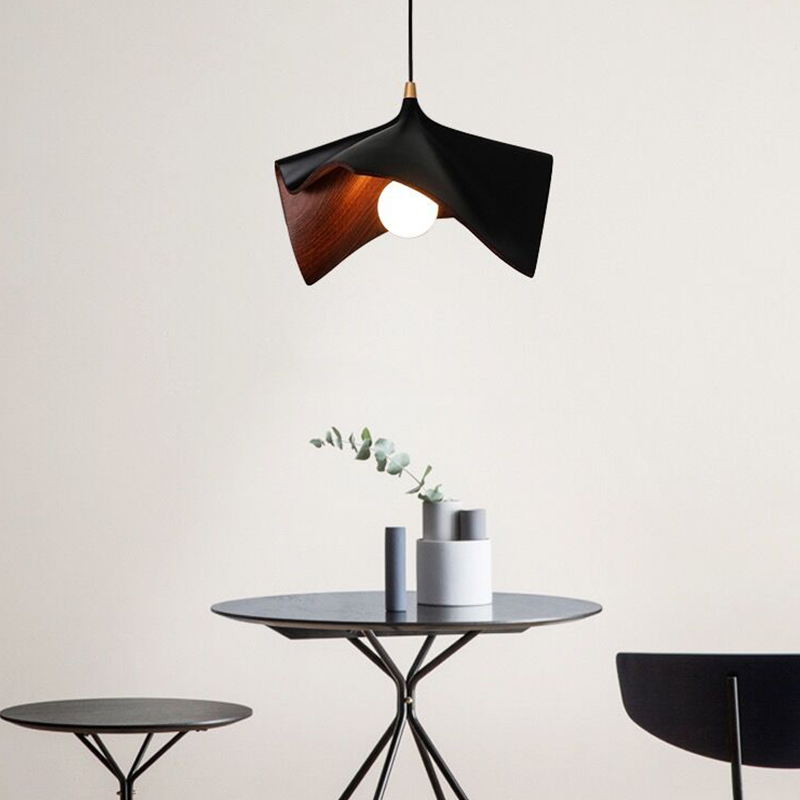 The Nordic wooden pendant light illuminating a modern dining area, enhancing the decor.