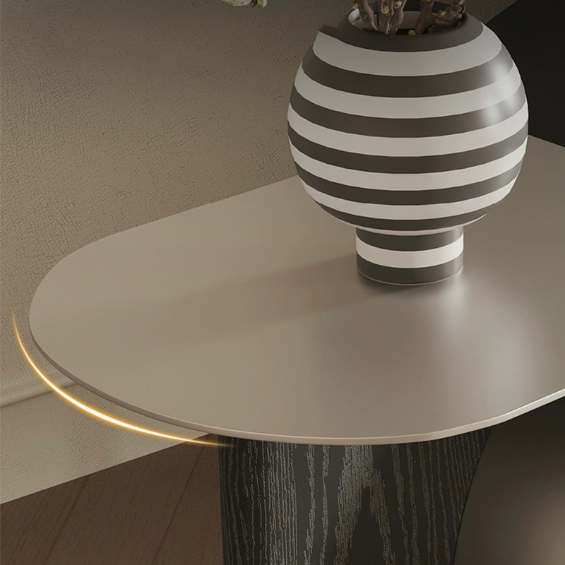 View of the Chic Crescent Moon Coffee Table with a cozy setup, featuring stylish decor items on the surface.