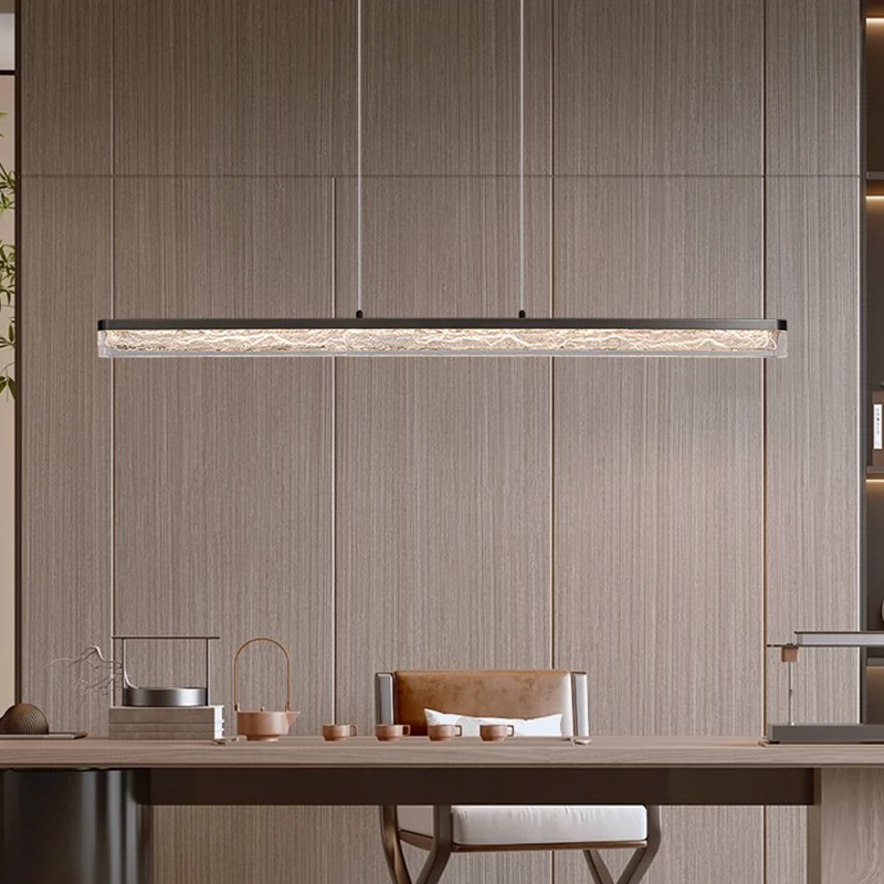 Sleek modern LED pendant light showcased above a contemporary dining table.