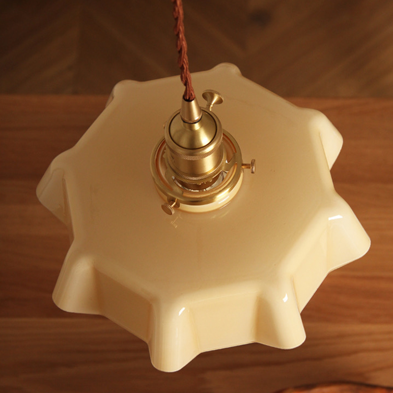 Wavy glass pendant light hanging in a stylish kitchen, showcasing its elegant design.