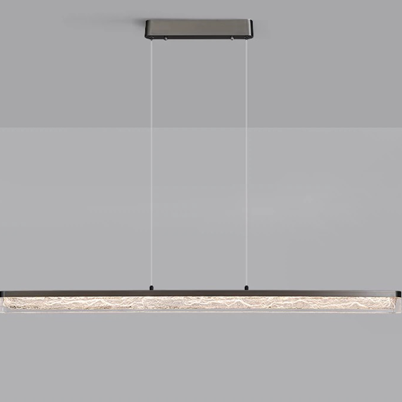 The long strip pendant light illuminating a stylish kitchen island.