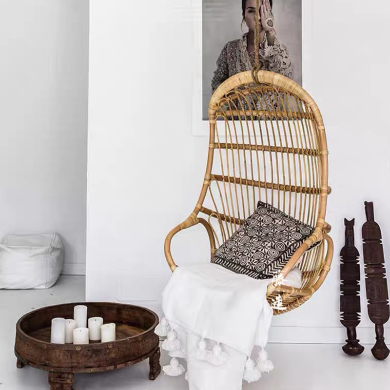 Elegant Rattan Indoor Glider Swing Chair in natural wood finish, perfect for cozy balconies.