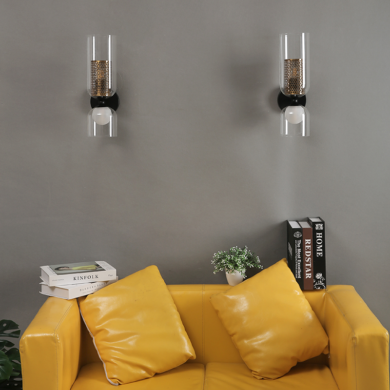 NordLight LED wall lamp mounted on white dining room wall with brass honeycomb detail.