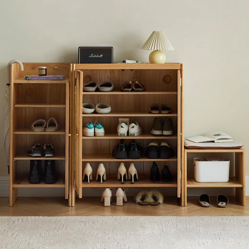 Side view showing the cabinets key and umbrella hanging features, emphasizing its creative shoe storage solutions.