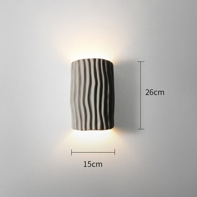 The modern wall light installed in a cozy living room setting