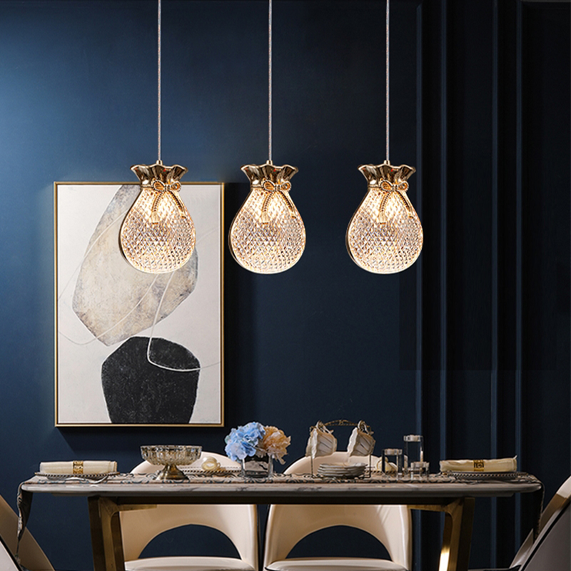 Elegant gold glass pendant light hanging in a modern dining room decor.