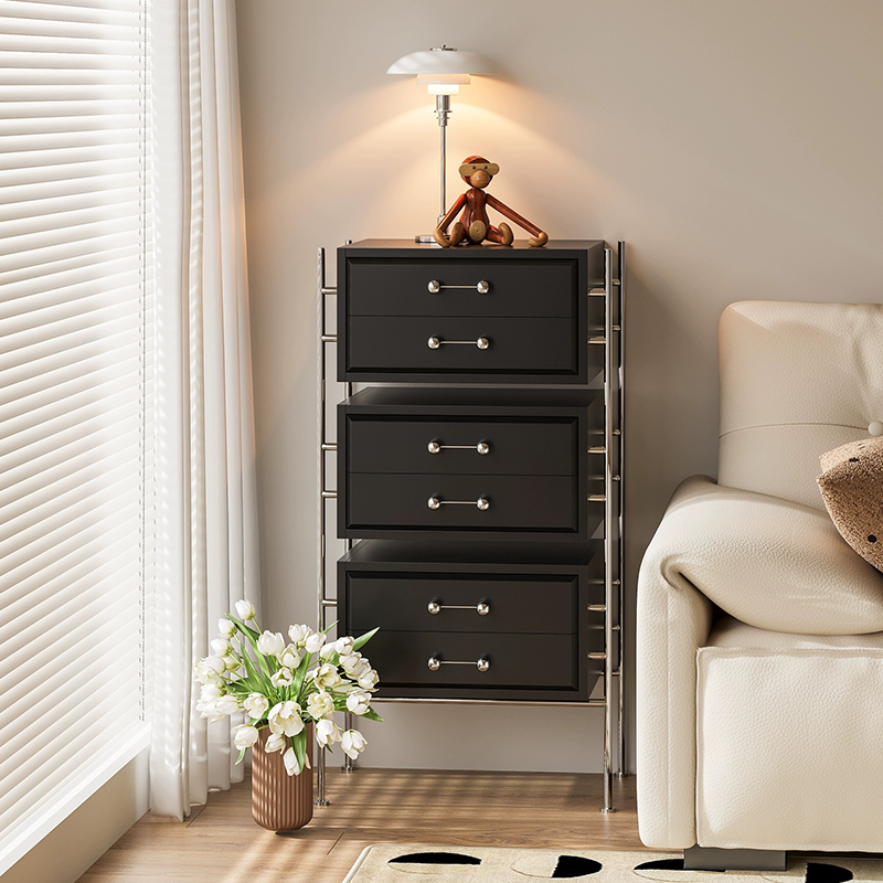 Stylish storage cabinet placed in an entryway, displaying lamps and books.