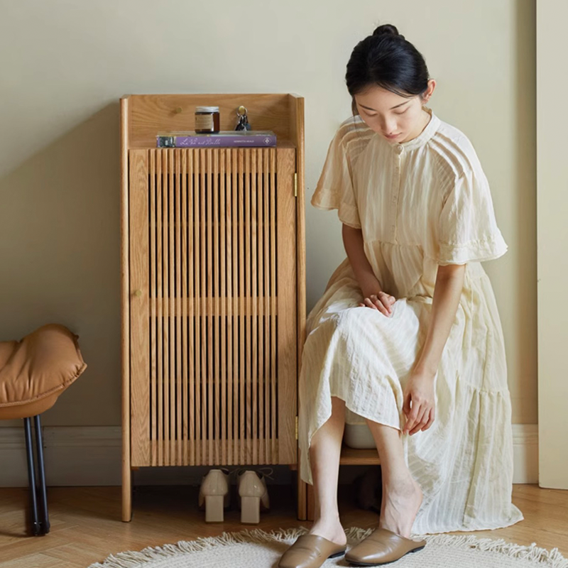 Close-up of adjustable dividers within the cabinet, illustrating how it accommodates different shoe types.