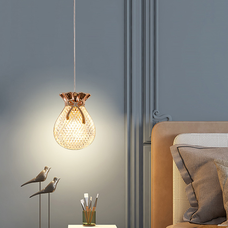 Pendant light illuminating a rustic kitchen island with a warm glow.
