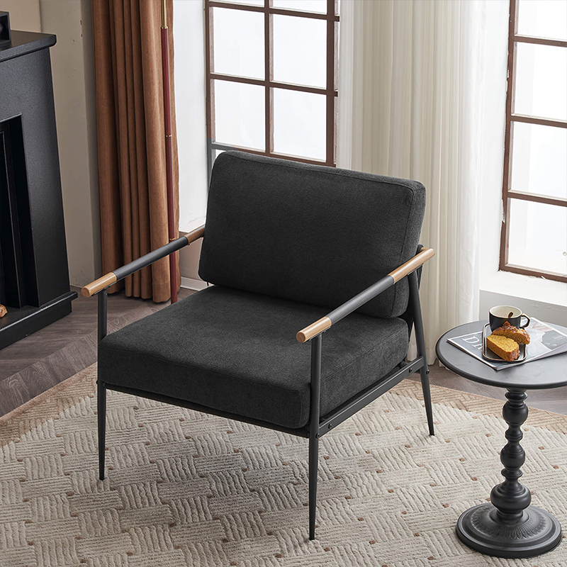 Side view of the sleek black chenille lounge chair with a metal frame in a cozy living room setting.